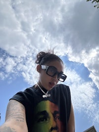 a woman wearing sunglasses and a t - shirt